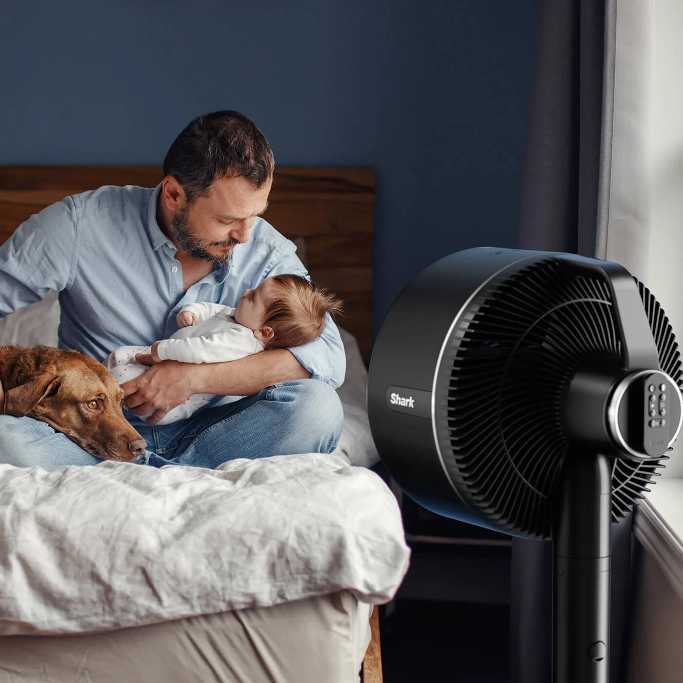 Image of man and baby in the bedroom with the Shark FA220UK
