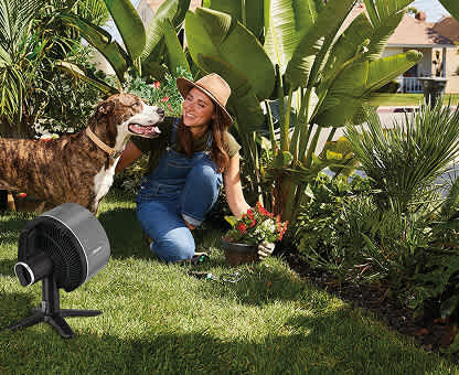 Image of woman gardening with her dog and the Shark portable FlexBreeze fan