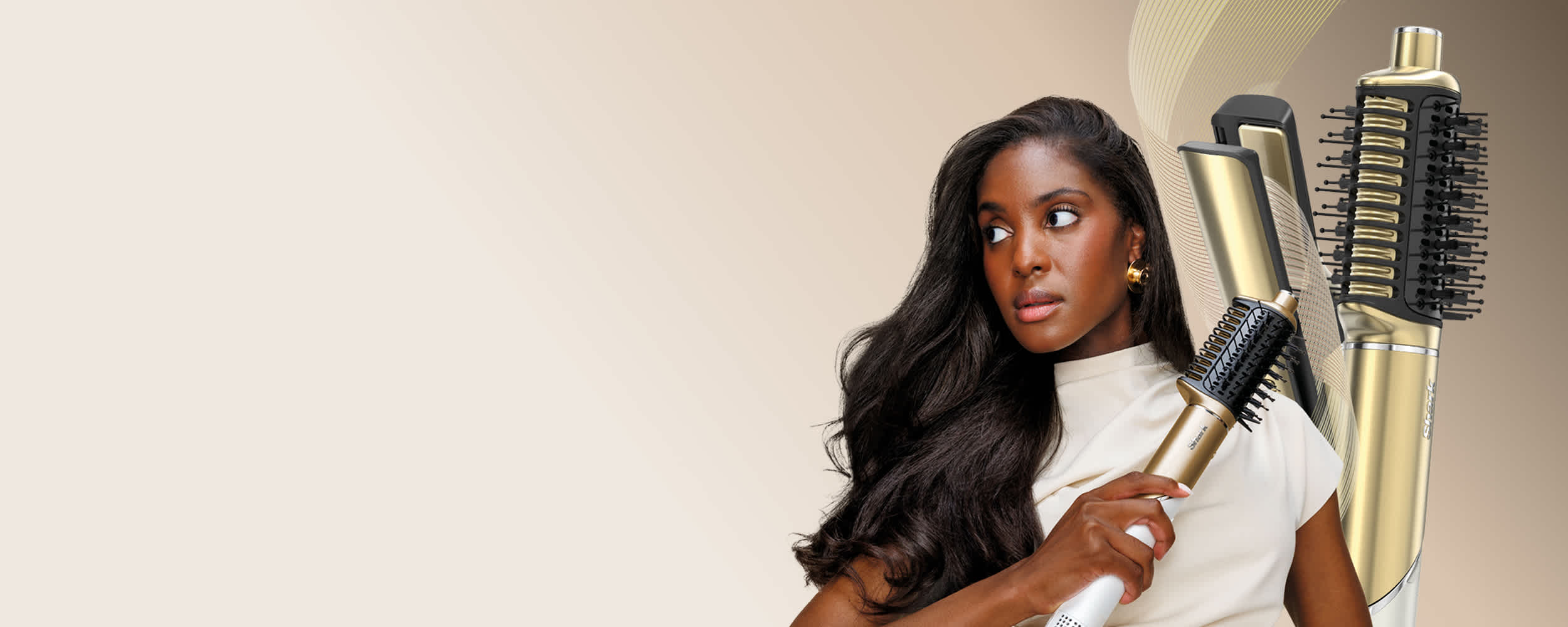 Shark hair styling tool with multiple brush and barrel attachments on a white marble surface.